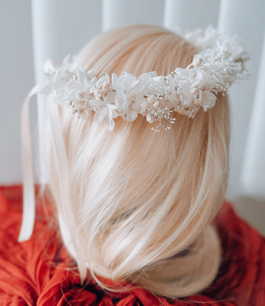 Back view of white wedding flower crown on blonde hair, elegant floral headpiece for bride