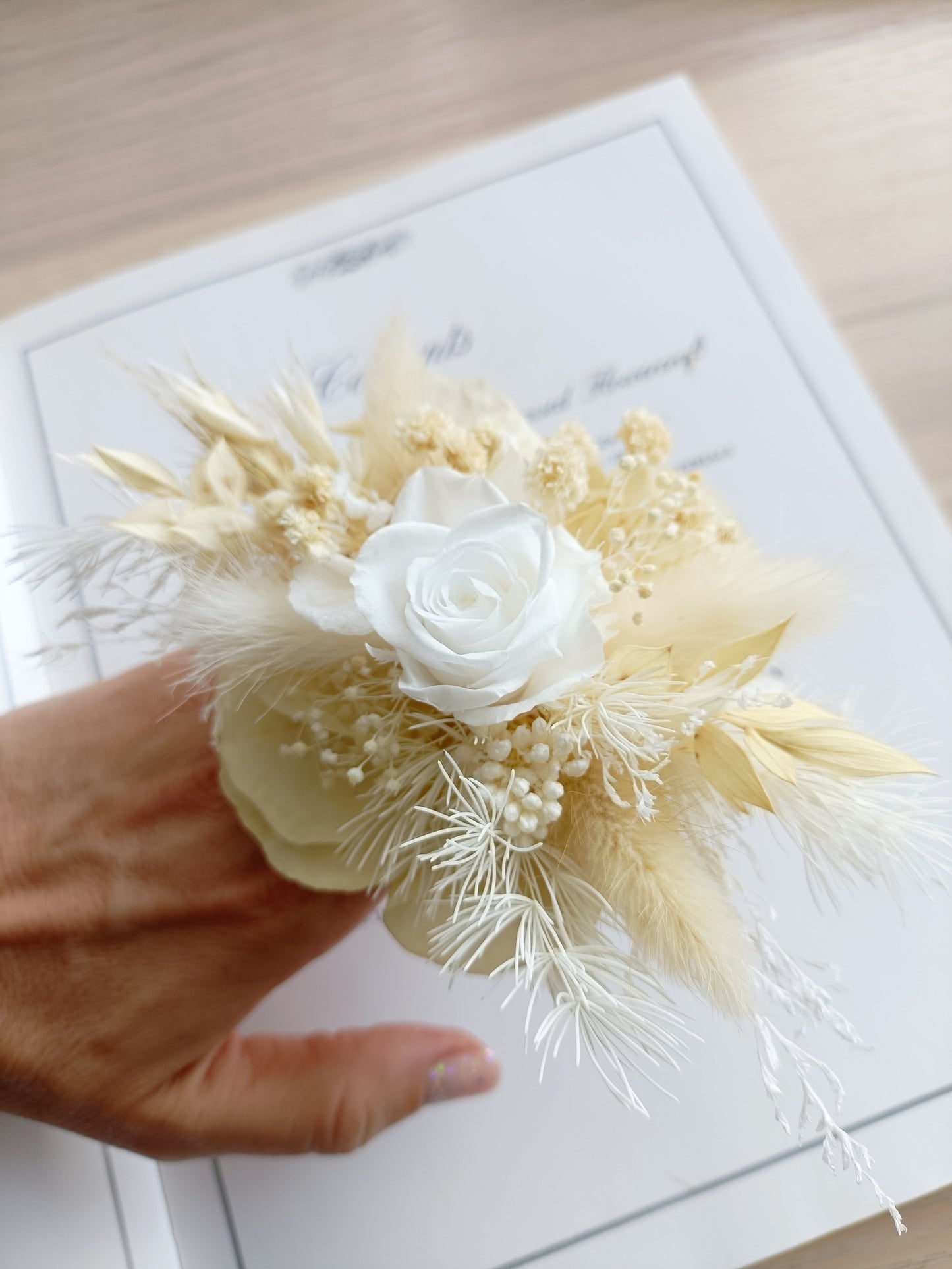 Preserved dried flower wrist corsage with sola rose and wheat accents, designed for weddings, formal events or rustic styling.