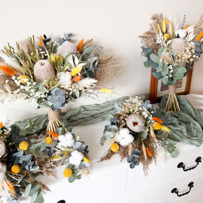 DRIED WEDDING flower arrangements on a white surface with a neutral background