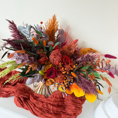 Autumn dried floral bouquet with preserved roses, eucalyptus and terracotta tones for home decor