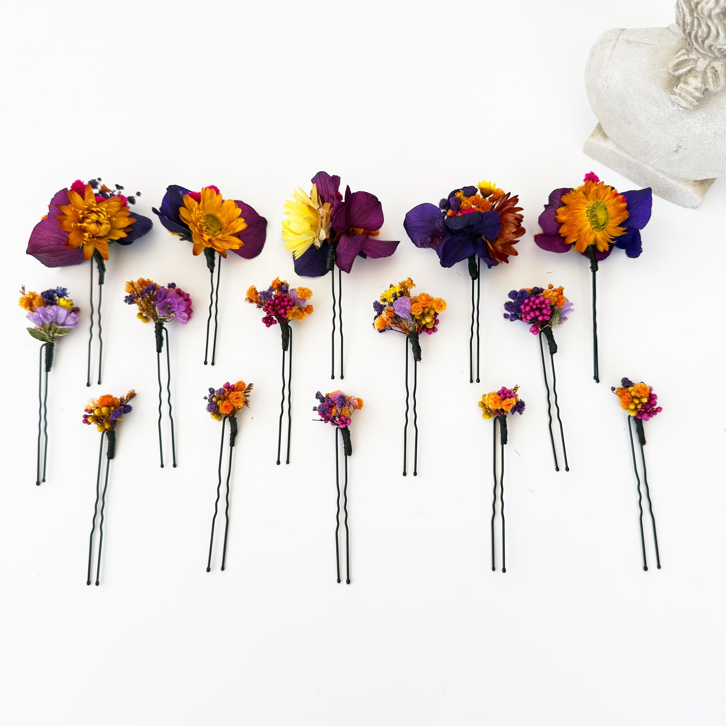 Dried flower hair pins displayed with braided hairstyle, handmade boho bridal accessories