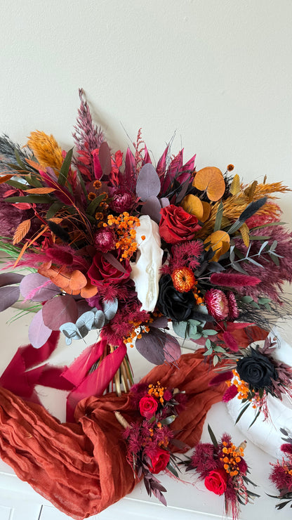 Bouquet of dried flowers with ribbons on a white background an white skull 