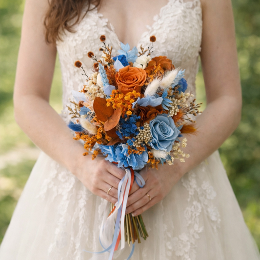 Bride holding a rustic burnt orange and blue bouquet of flowers 
