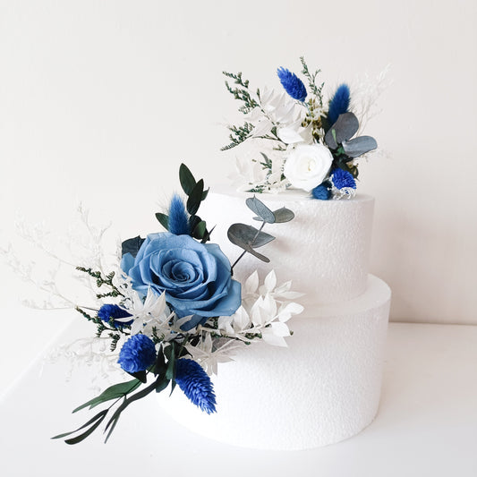 Blue and white dried flower cake topper on white two-tier cake – wedding decor handmade in Australia