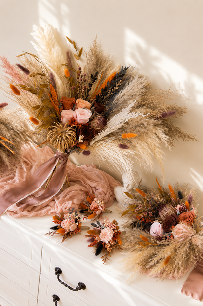 Matching bridesmaid bouquet and boutonniere set with preserved flowers and pampas grass.