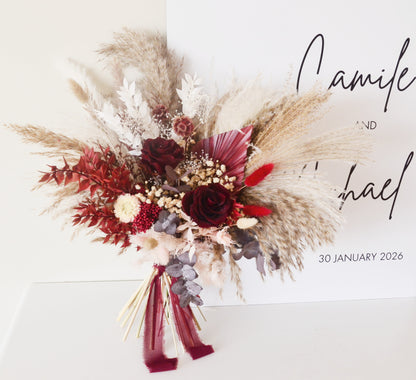 Large boho wedding bouquet with pampas grass, preserved burgundy roses and rustic dried flowers for bride.