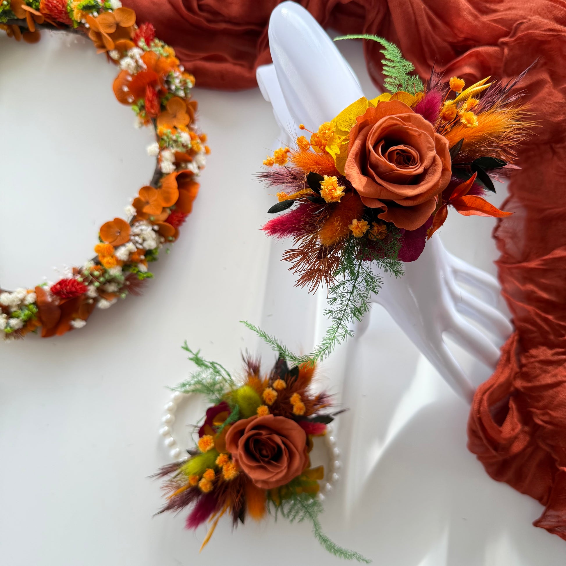 Rust and terracotta dried flower wrist corsage with preserved roses and native Australian foliage