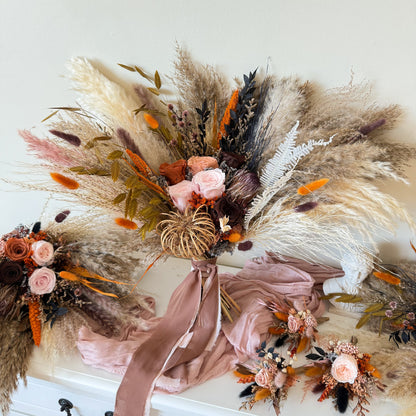 Large boho bridal bouquet with pampas grass, preserved roses and matching wedding accessories in neutral terracotta tones.