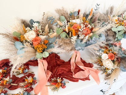 Rustic boho wedding bouquet featuring preserved orange and ivory roses, pampas grass, eucalyptus, and sola wood flowers, perfect for autumn Australian weddings.