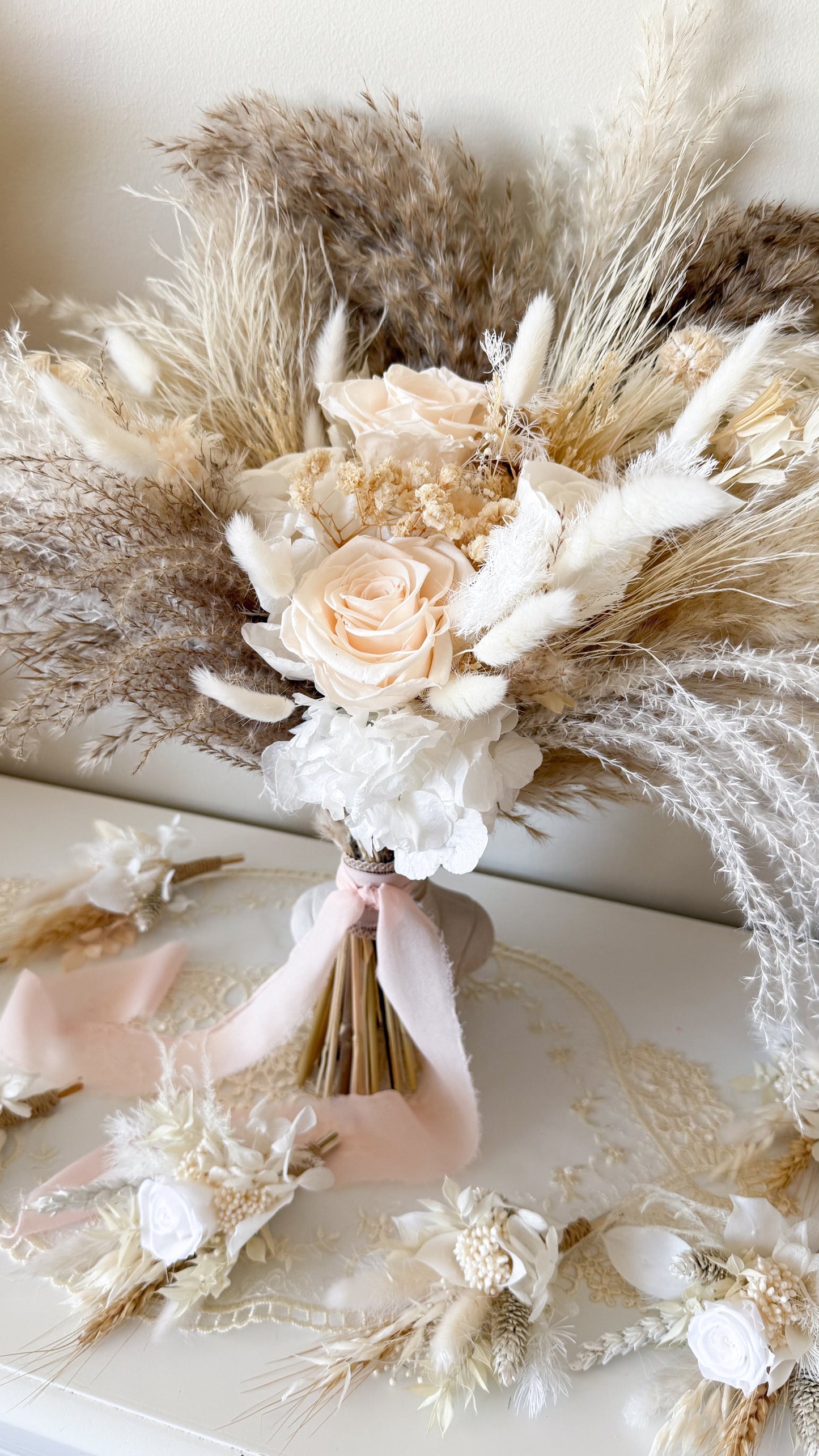 Bouquet of dried flowers and roses on a textured surface