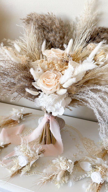 Bouquet of dried flowers and roses on a textured surface
