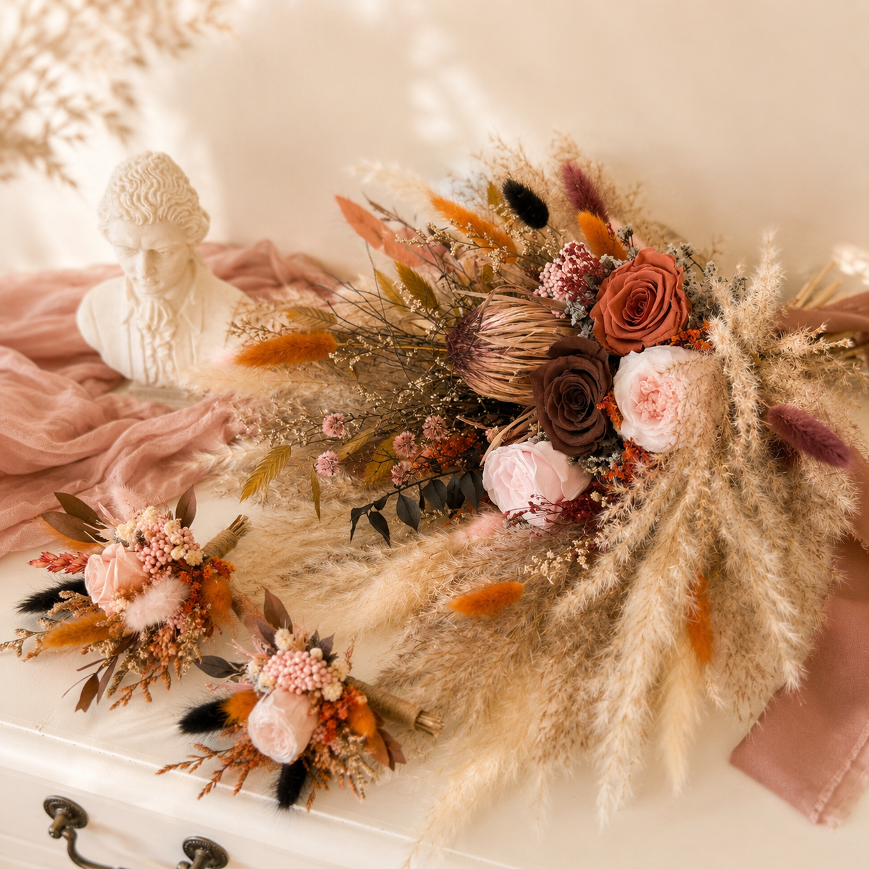 Boho dried flower boutonniere with preserved flowers in terracotta and blush tones.