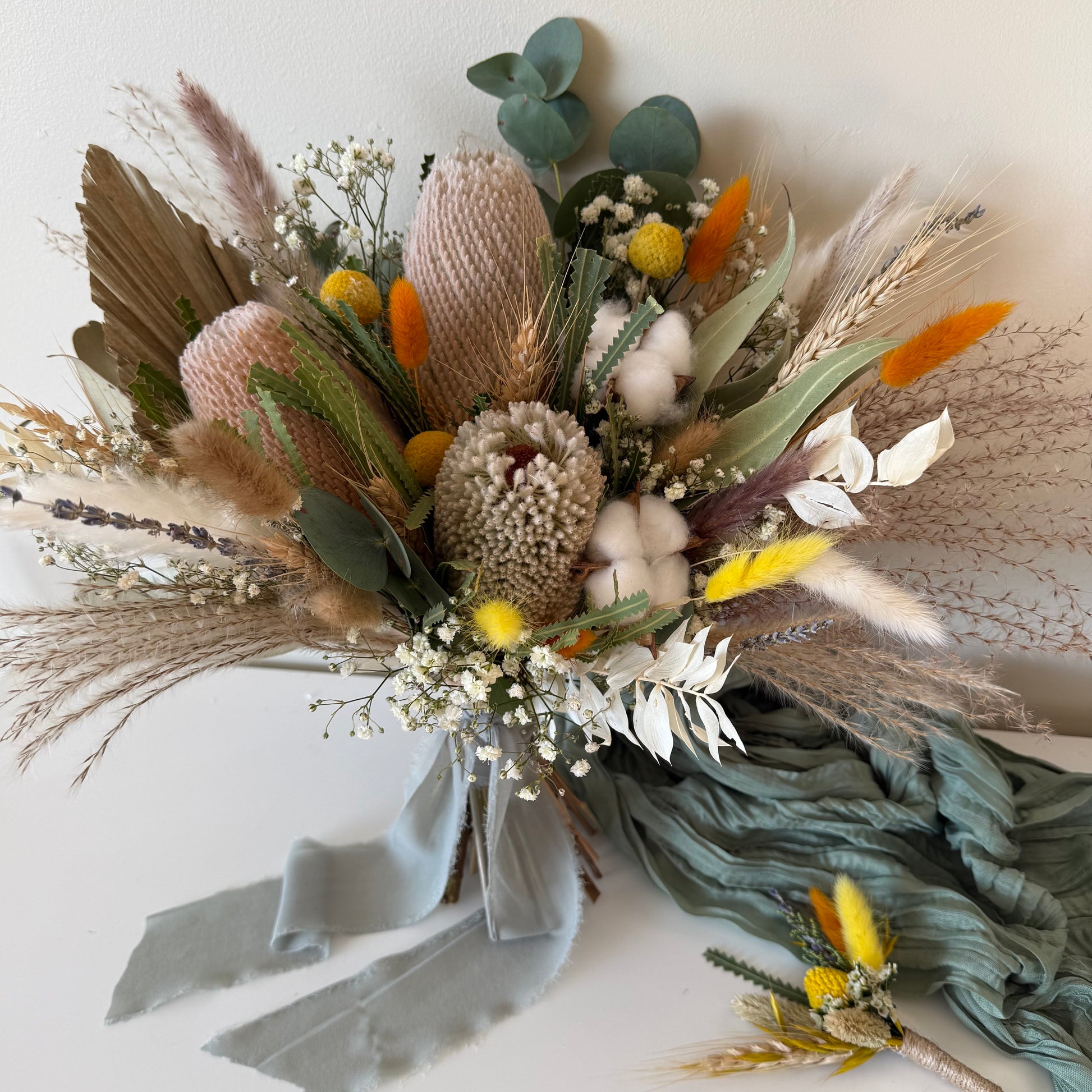 Bouquet of dried flowers with BANKSIA AND greenery on a light background