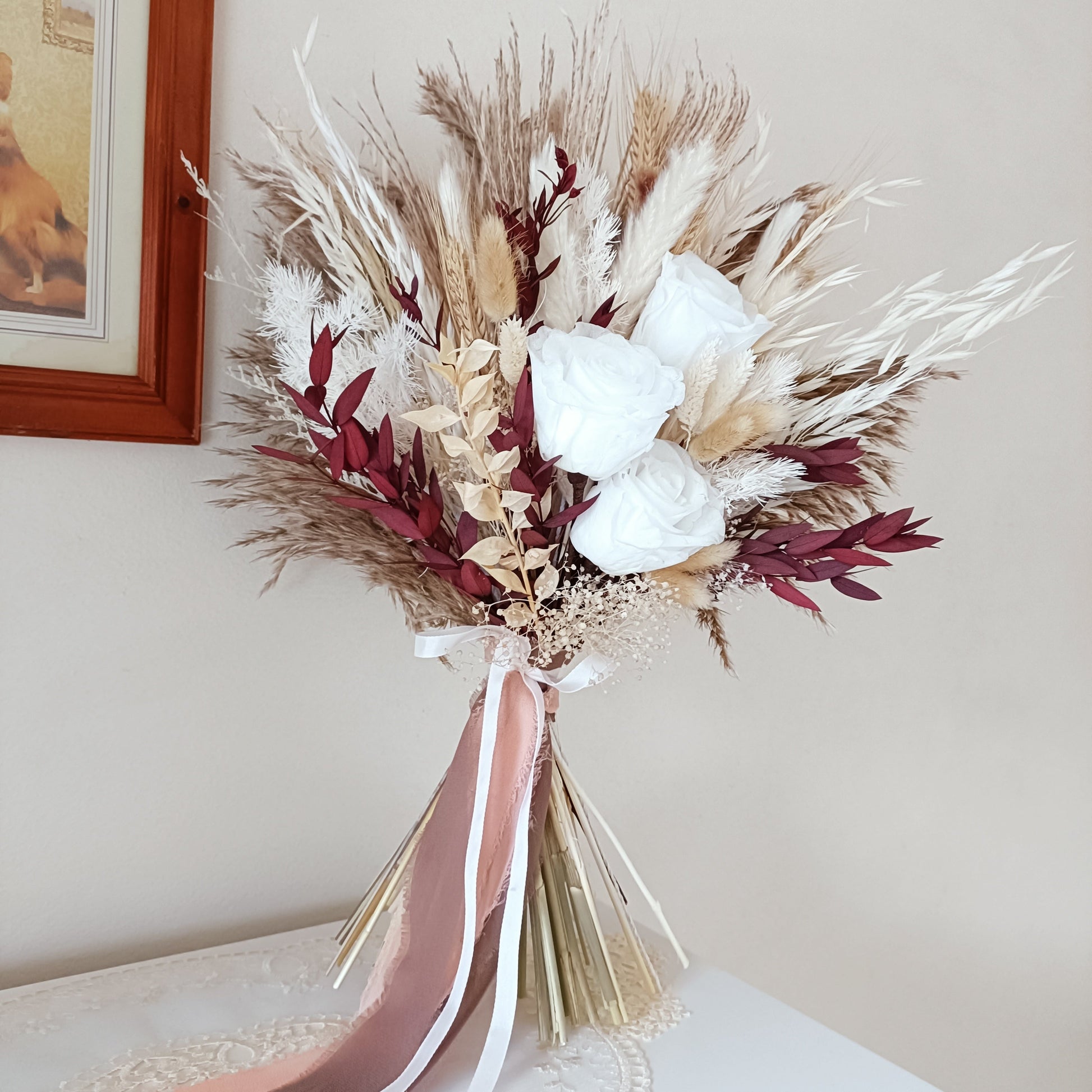 Burgundy Rose Bridal Bouquet,Dried Flower Wedding,Boho Wedding Bouquet,Pampas Bouquet,Burgundy Boho bridal bouquet with preserved pampas grass, bleached ruscus, burgundy bunny tails, and ivory sola flowers. Held by hand to show natural movement and scale. This long-lasting bouquet is ideal for modern Australian weddings with earthy styling.

