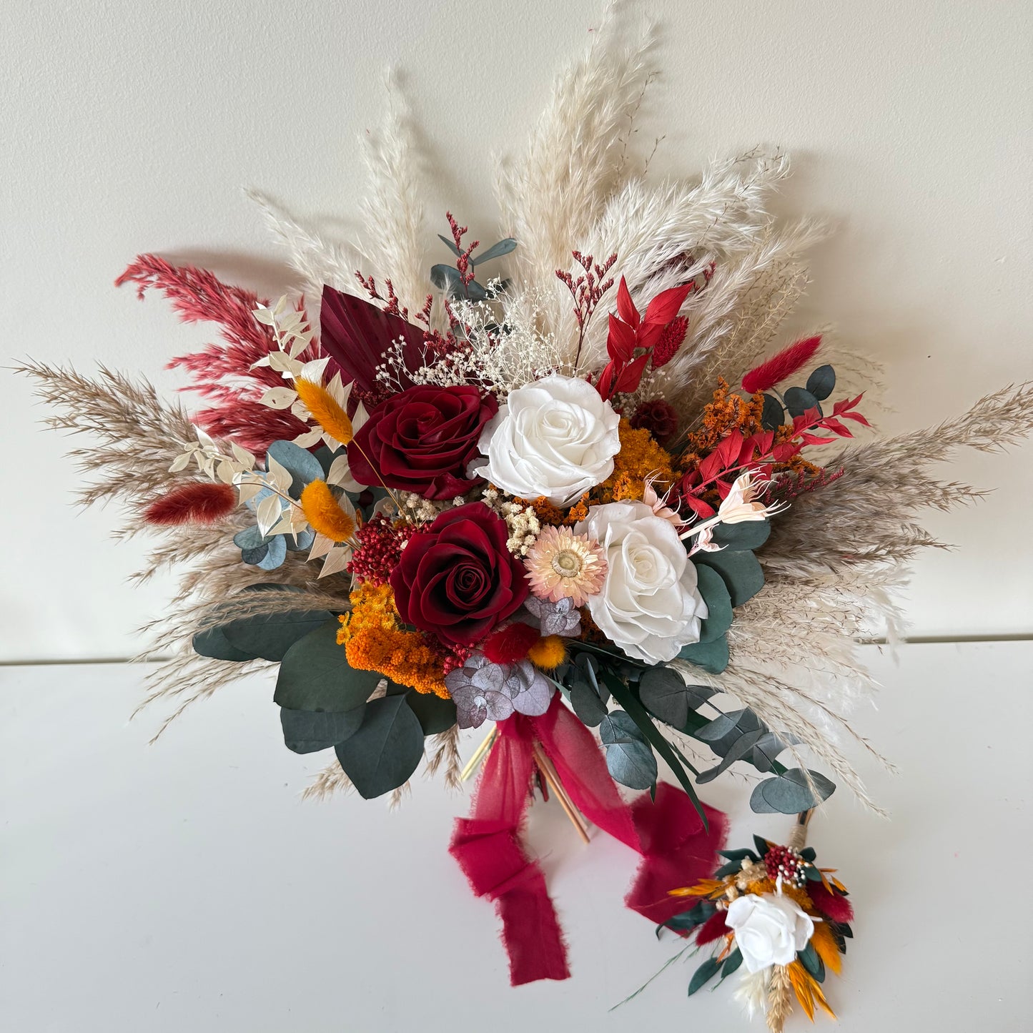 Bouquet of flowers with red, white, and green colors on a white background