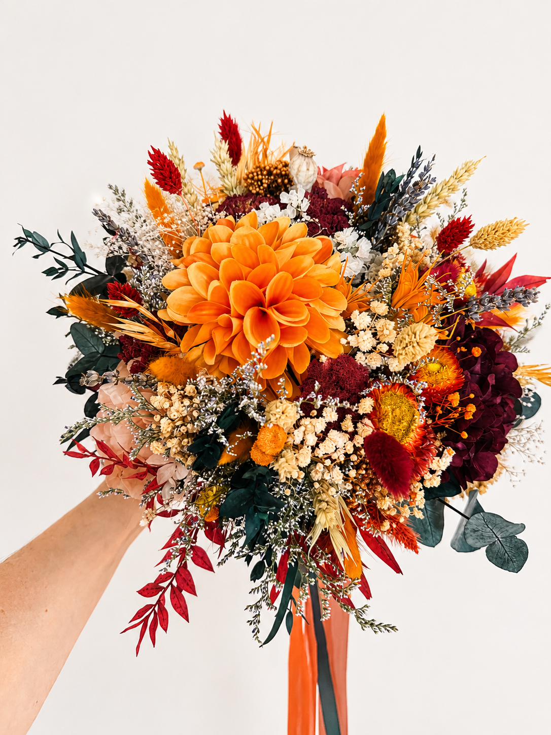 Large handmade bridal bouquet with burnt orange dahlia, burgundy hydrangea, preserved eucalyptus and dried flowers for an autumn wedding.