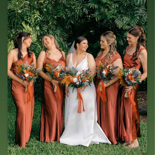 Burnt orange and terracotta dried wedding flowers featuring bridal bouquet, bridesmaid bouquets, ceremony florals and preserved wedding arrangements in warm earthy tones.