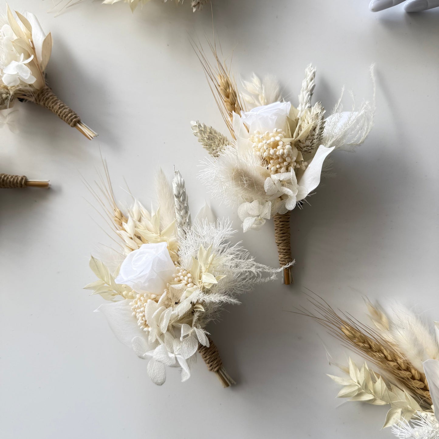 Champagne and ivory boutonniere with preserved rose, dried flowers and wheat accents