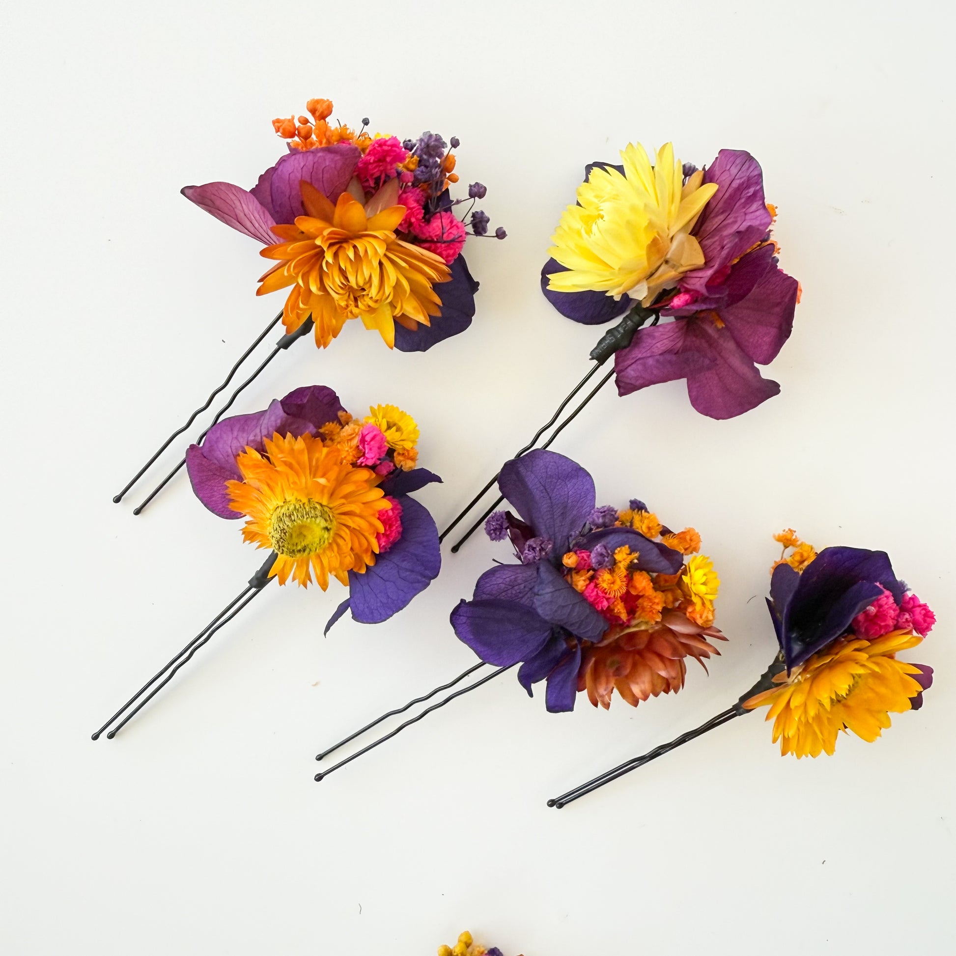 Colorful flower hairpins on a white background