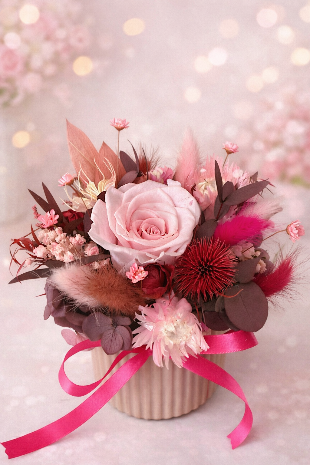 Floral arrangement with pink roses and decorative elements on a soft background