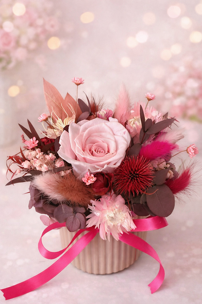 Floral arrangement with pink roses and decorative elements on a soft background