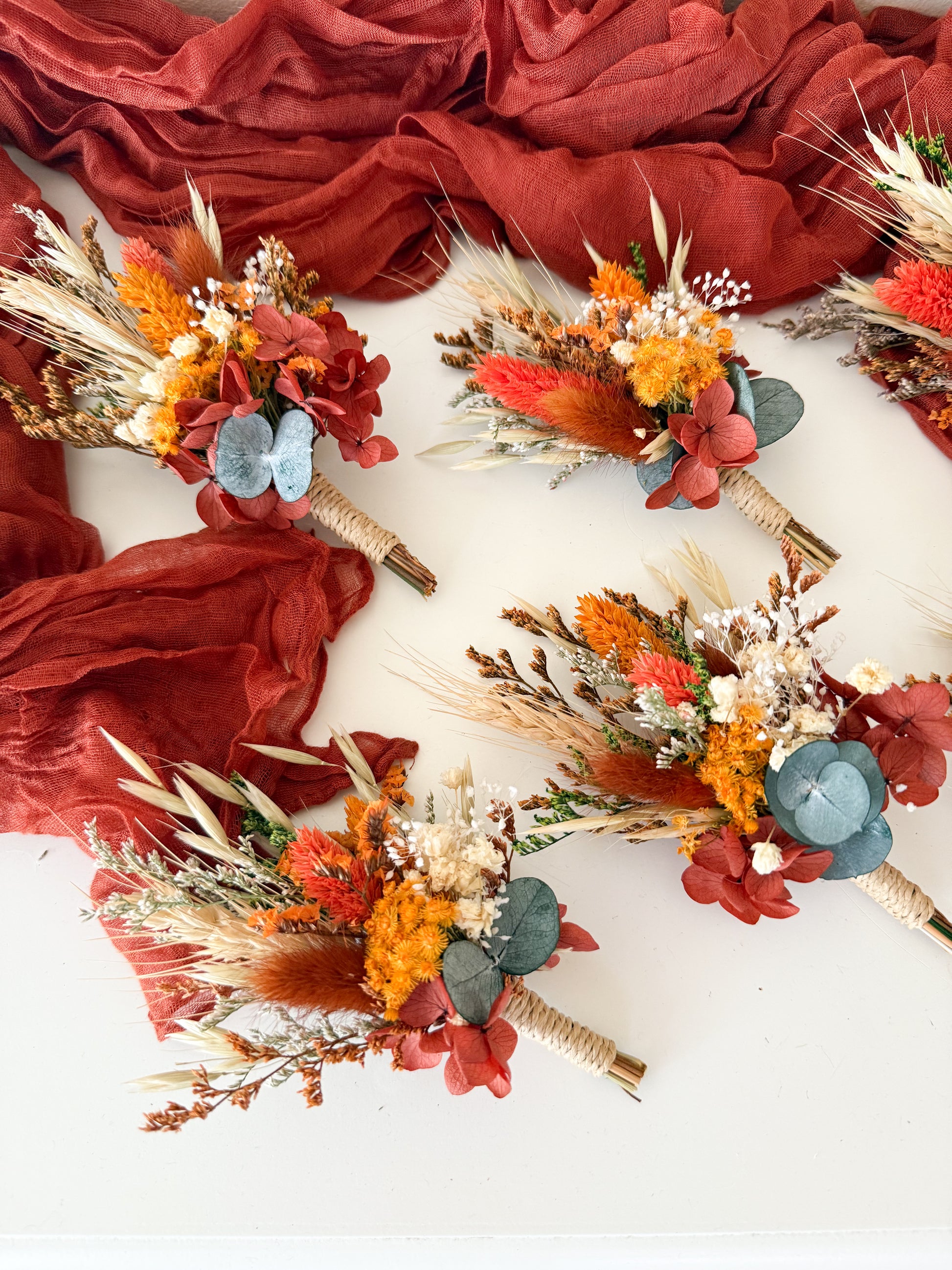 Set of dried flower boutonnieres in matching burnt orange and beige tones — perfect for groomsmen, rustic or boho weddings in Australia.