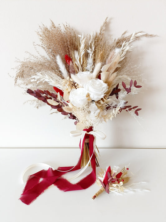 Dried flower bridal bouquet in ivory, beige and burgundy tones with pampas grass, sola roses, preserved leaves and bunny tails, finished with a deep red velvet ribbon. Includes matching boutonnière. Perfect for rustic, boho or autumn weddings in Australia.