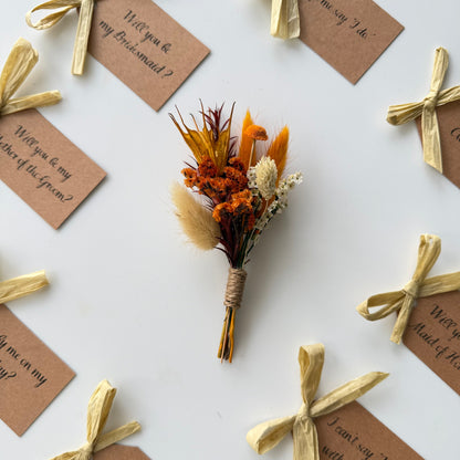 Dried flower bouquet with tied ribbons and question tags on a white background