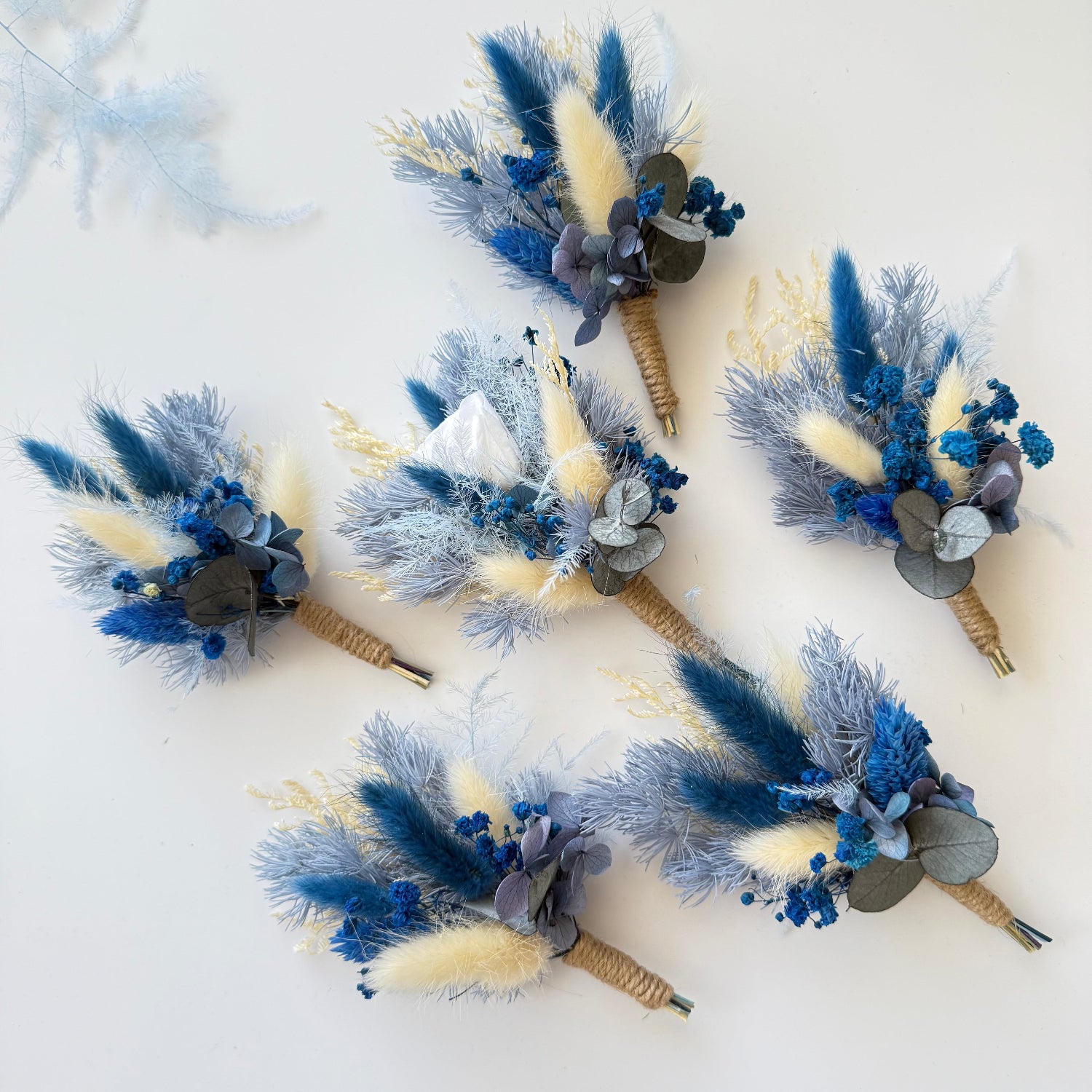 Handmade dried flower boutonniere set in dusty blue, ivory and beige tones, perfect for rustic and boho weddings.