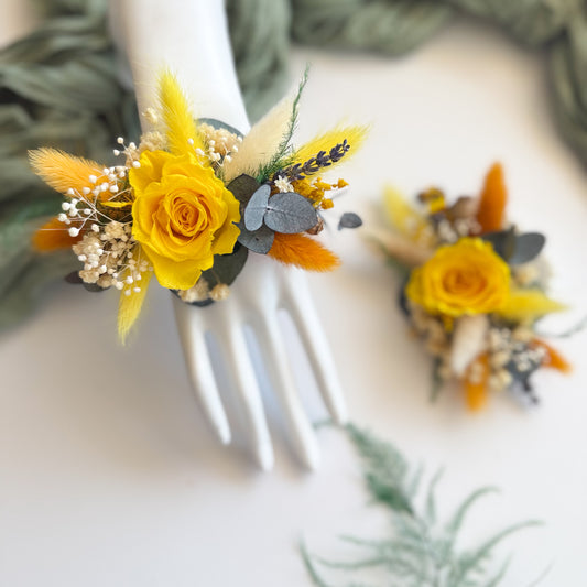 Close-up video of yellow dried flower wrist corsage â€” preserved rose and eucalyptus design for bridesmaids or mothers.