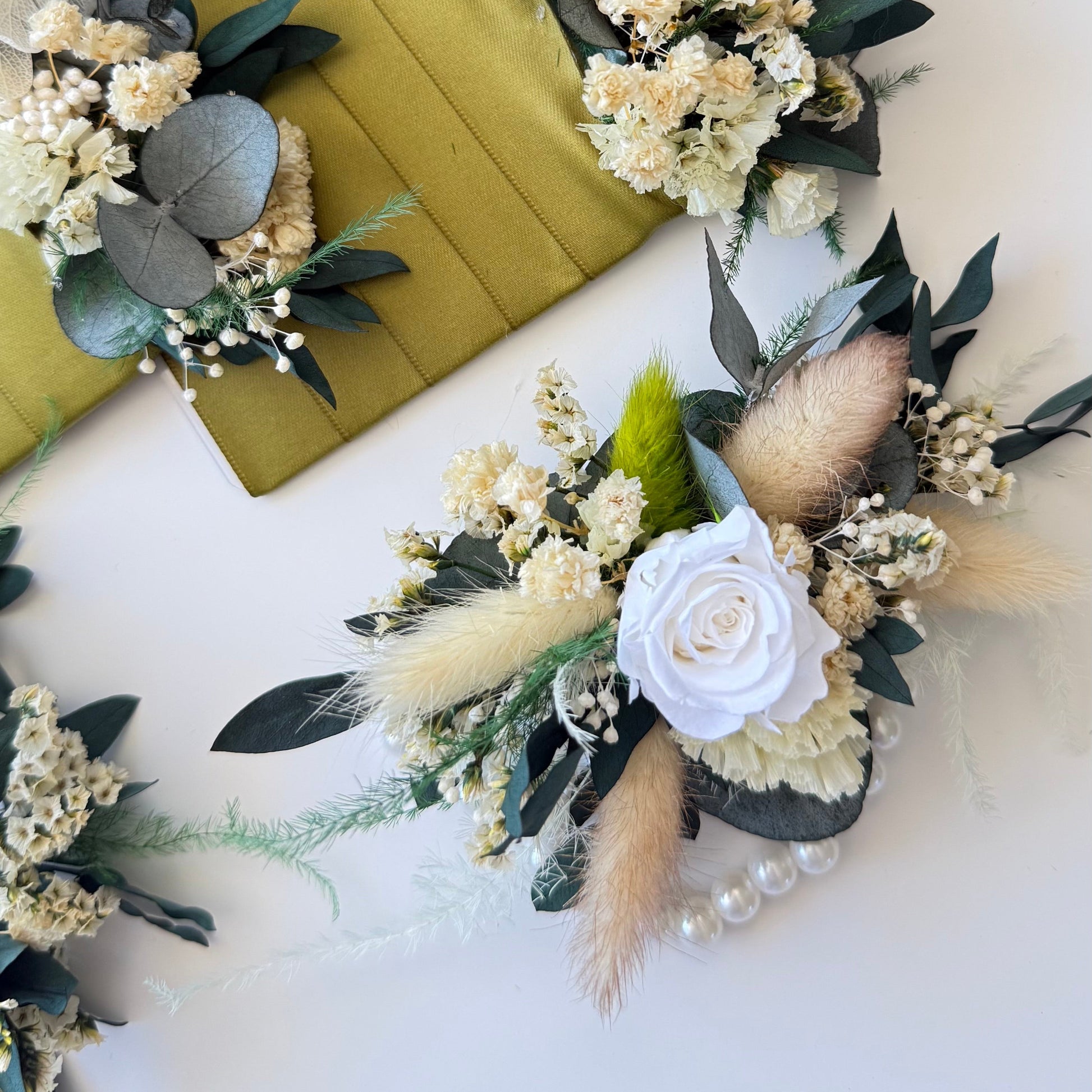 Ivory and beige dried flower wrist corsage with preserved greenery, perfect for rustic weddings.