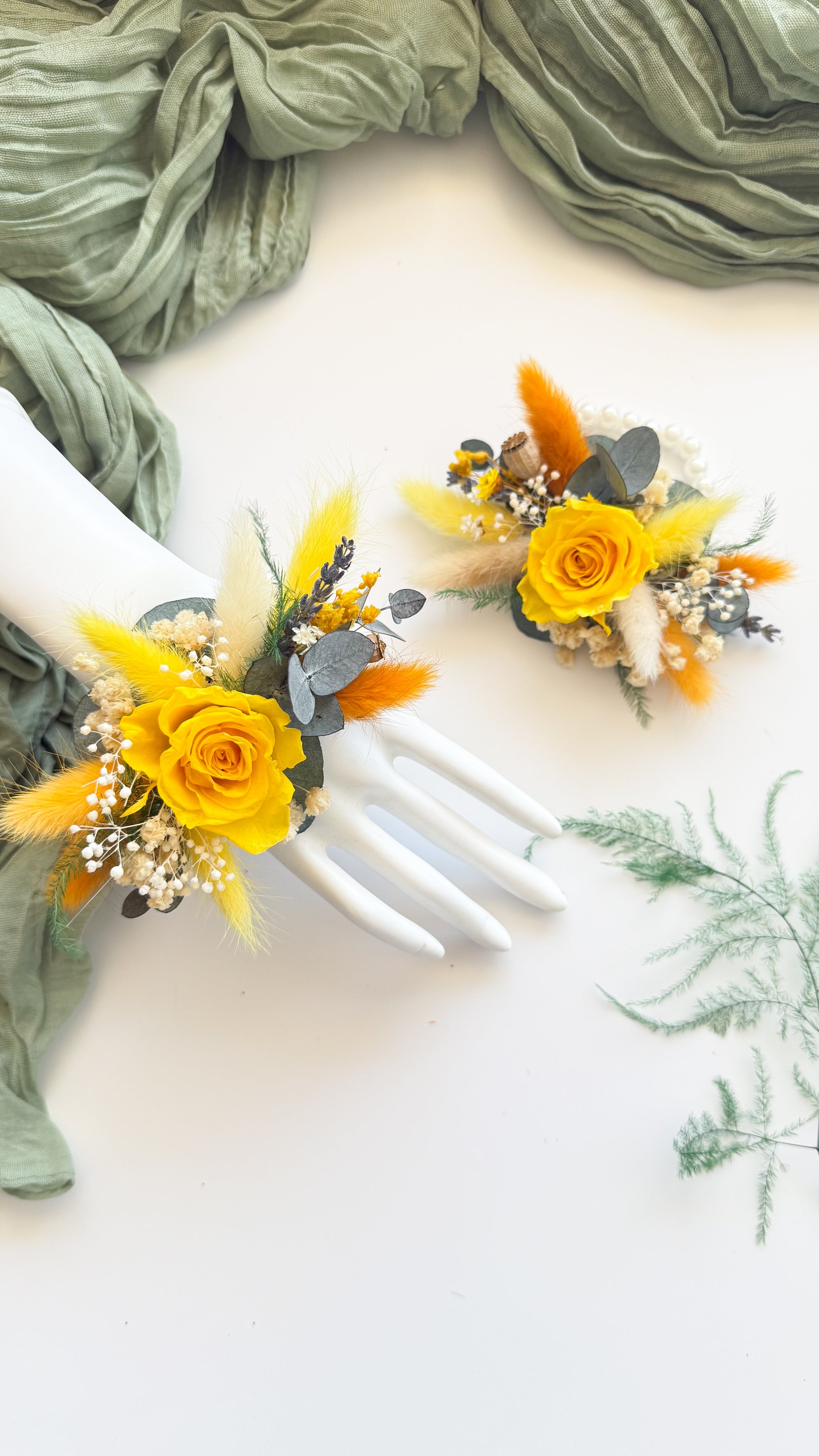 Golden yellow preserved rose corsage with eucalyptus and babyâ€™s breath â€” elegant dried wedding flower accessory.