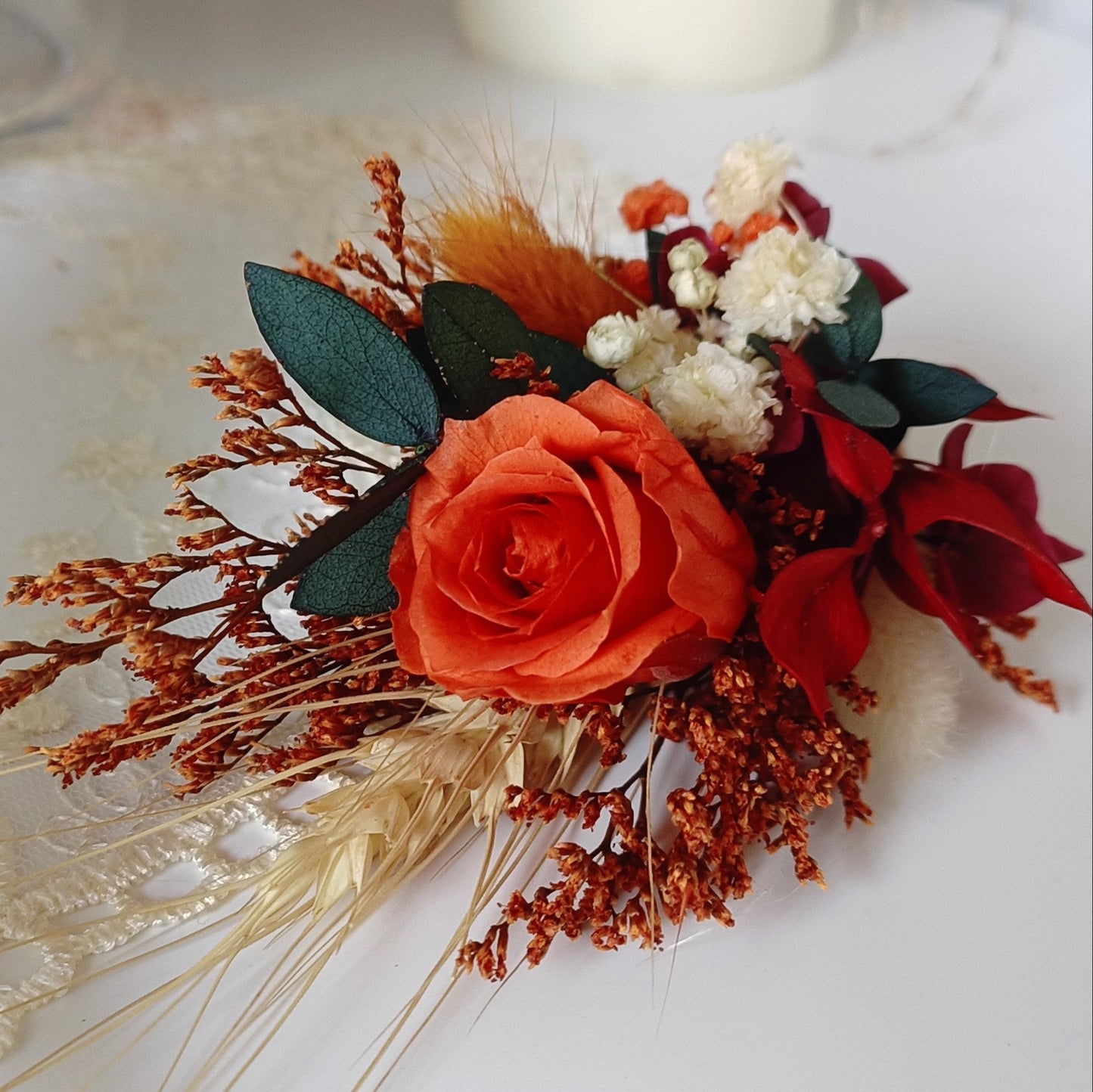 Handmade boho bridal crown and boutonniere with preserved flowers in deep red, burnt orange, and ivory hues