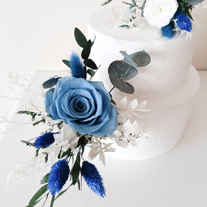 Handmade floral cake topper set featuring eucalyptus, sola flowers, and dried blue thistles