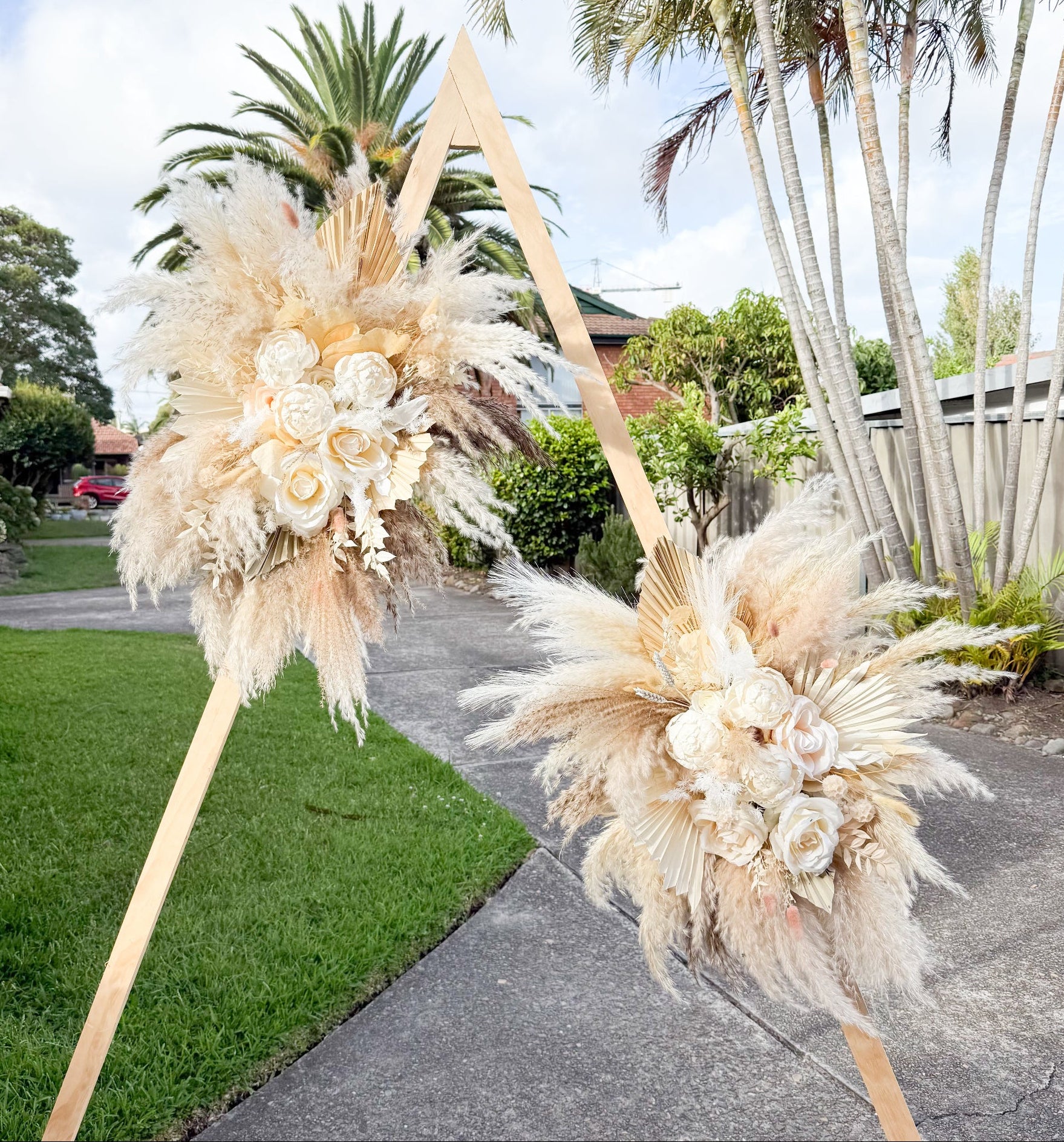 Large pampas grass wedding floral installation featuring dried flowers and sola peonies for statement ceremony decor.