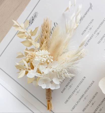 Minimal wedding boutonniere made with sola peonies and dried pampas grass, ideal for modern and elegant bridal looks.