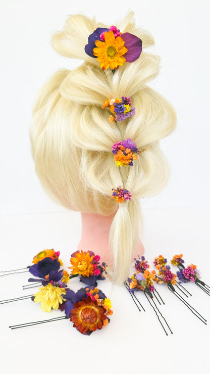 Blonde wig with colorful floral hairpins on a white background