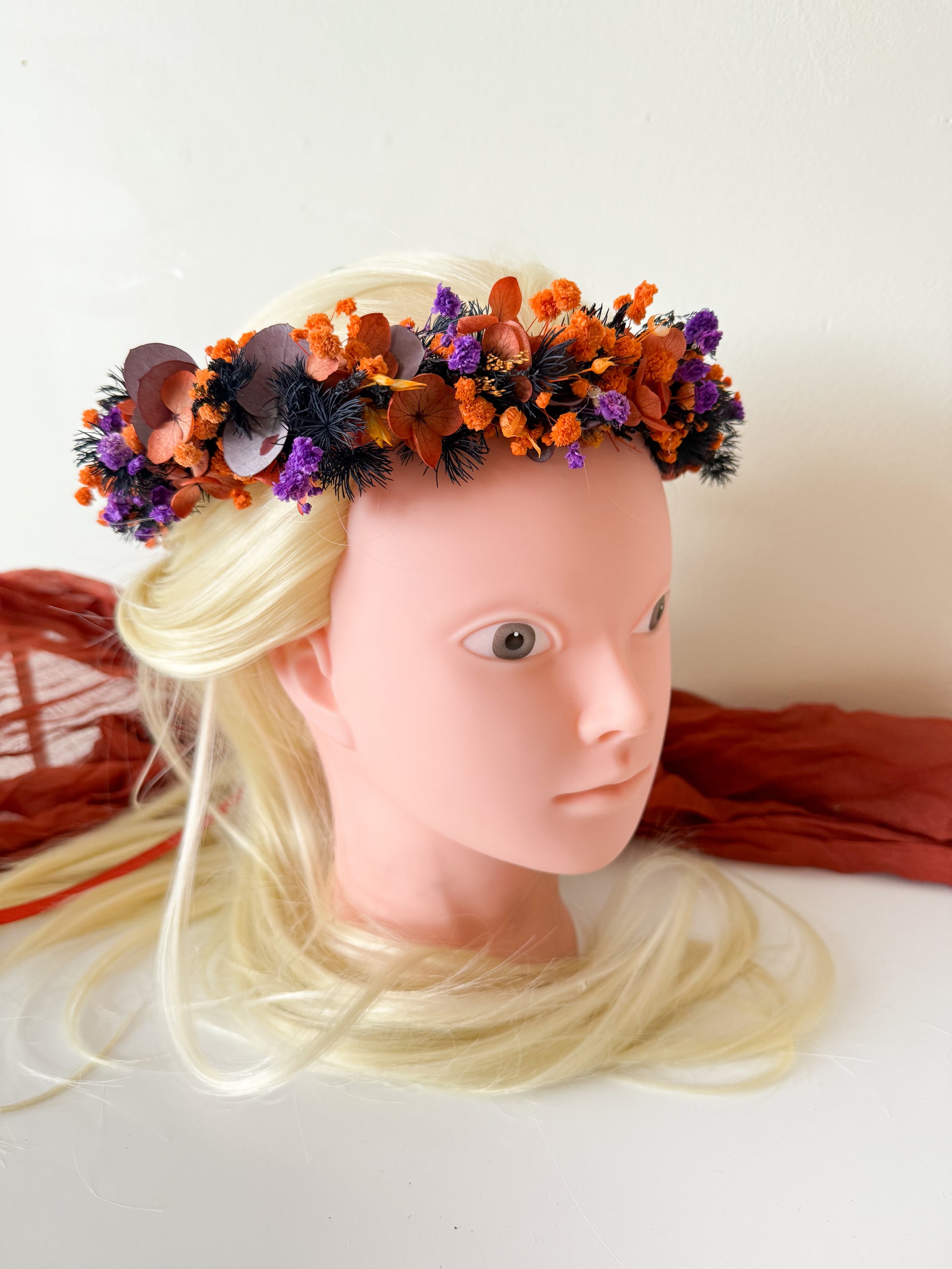 Close-up front view of dried flower headpiece in bright orange and purple tones — rustic and elegant bridal flower crown.