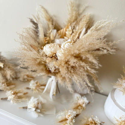 Neutral dried Bridesmaids bouquet with pampas grass and sola peonies, styled as a refined floral display.
