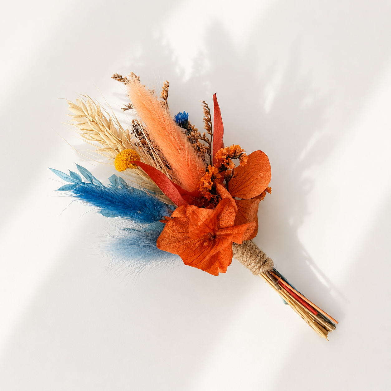 Mini dried flower bouquet with vibrant orange flowers and blue preserved bunny tails for unique bridesmaid proposal gifts.