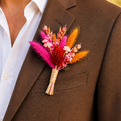 brown suit with a colorful boutonniere outdoors.