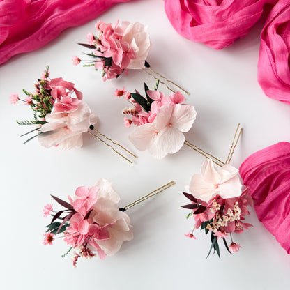 Floral hairpins on a white background with pink fabric