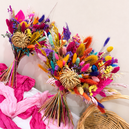 Handcrafted rainbow dried bridal bouquet featuring vibrant preserved flowers in pink, purple, orange, yellow and blue, perfect for a colourful boho wedding in Australia.