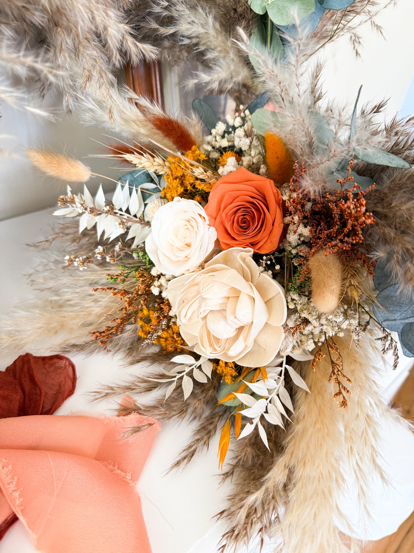 Close-up of rustic bridal bouquet with preserved roses, bunny tails, and eucalyptus in warm autumn colors — handmade in Sydney, Australia.