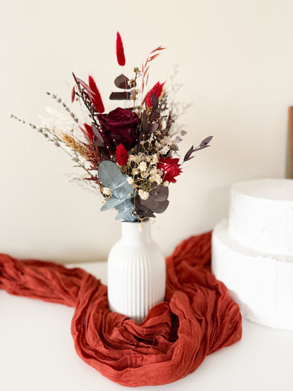 Rustic dried floral vase with preserved red rose, eucalyptus gum leaves, and natural grasses – long-lasting wedding or home arrangement
