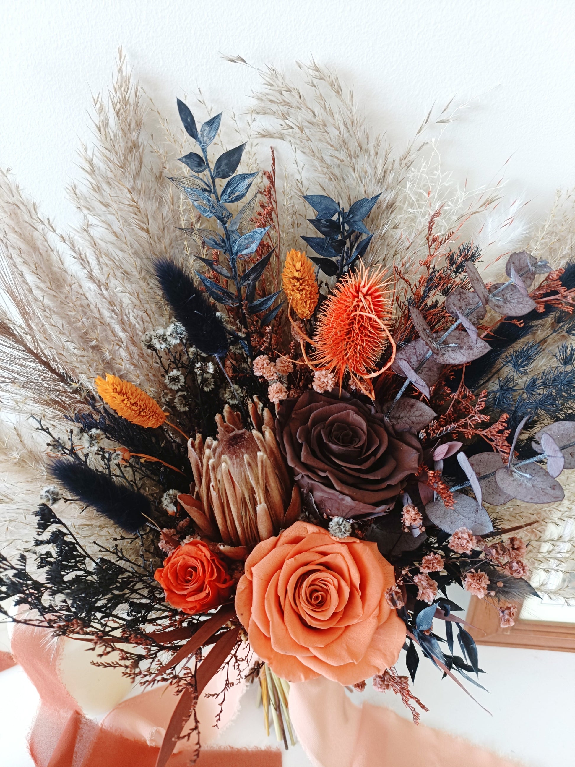Rustic dried flower wedding set with bouquet, boutonniere, and hair pins – handcrafted with orange, navy, and neutral botanicals.