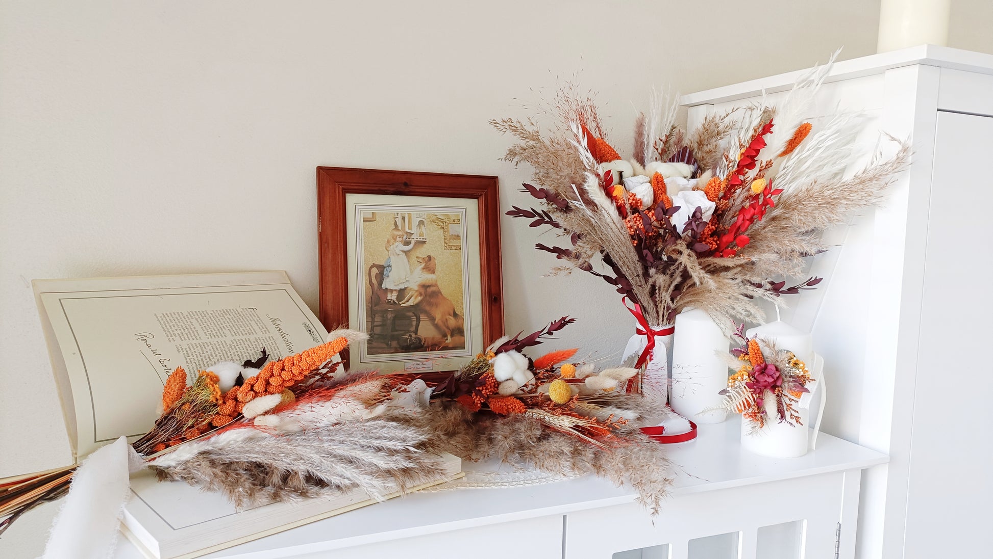 This eye-catching wedding bouquet features a bold combination of red, orange, and natural hues, crafted from a selection of dried flowers. The arrangement includes pampas grass, preserved foliage, and textured accents, offering a rustic yet vibrant look perfect for autumn weddings. Long-lasting and full of character, this bouquet adds a fiery touch to any bridal ensemble. Explore our collection for more unique and seasonal wedding bouquets.