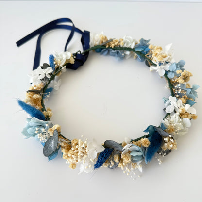 Floral wreath with blue and white flowers on a white background
