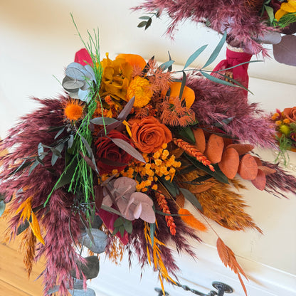 Colorful floral arrangement with pampas grass and autumnal flowers on a white background