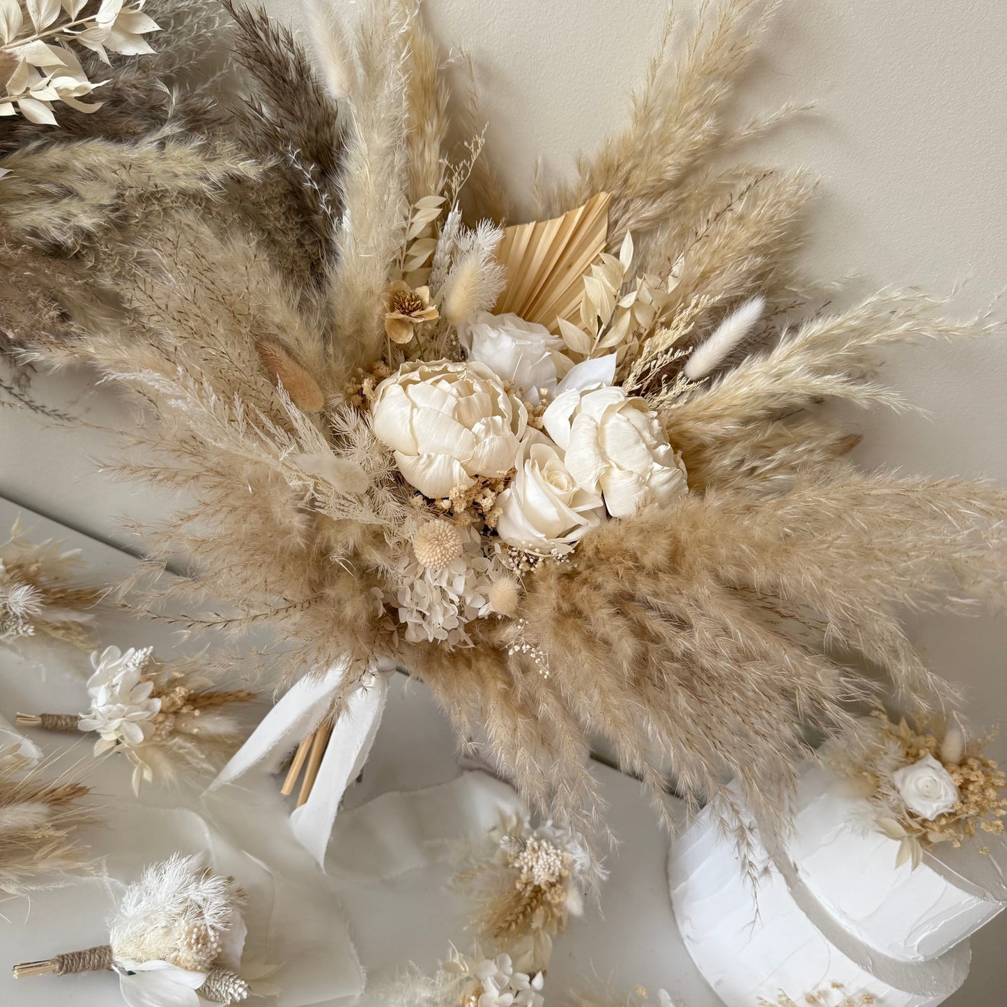 Textured pampas grass wedding bouquet with sola peonies, created in soft natural tones for luxury wedding aesthetics.